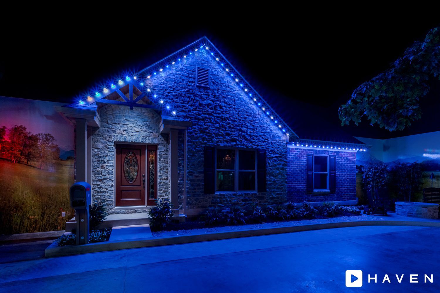 A house with christmas lights on it is lit up at night.