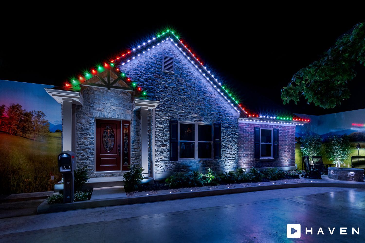 A house with christmas lights on it is lit up at night.