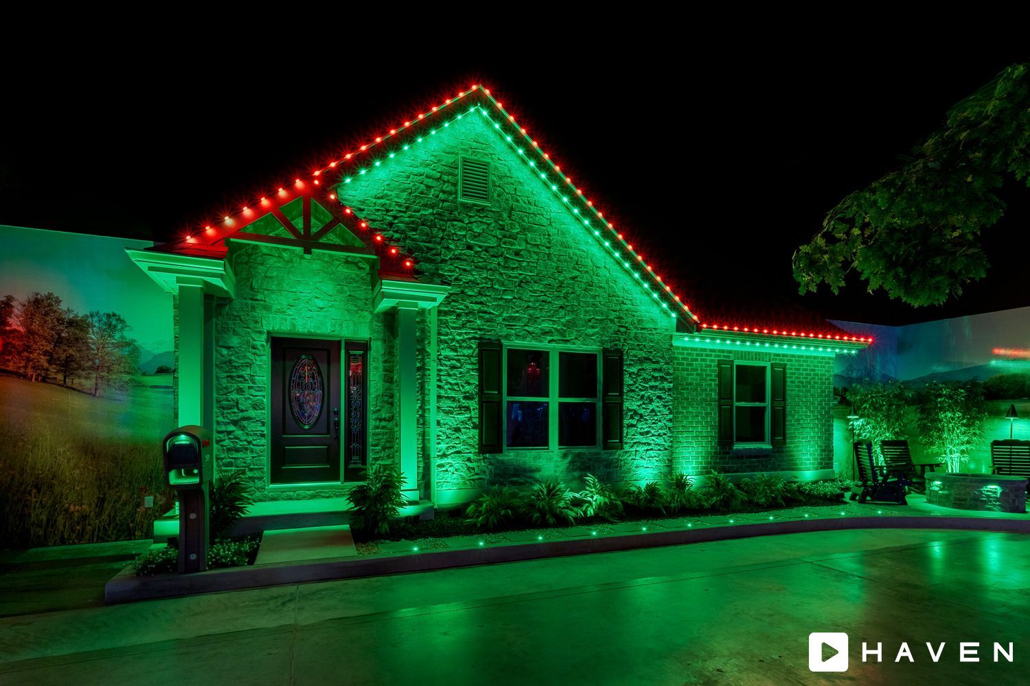 A house is lit up with green and red lights at night.