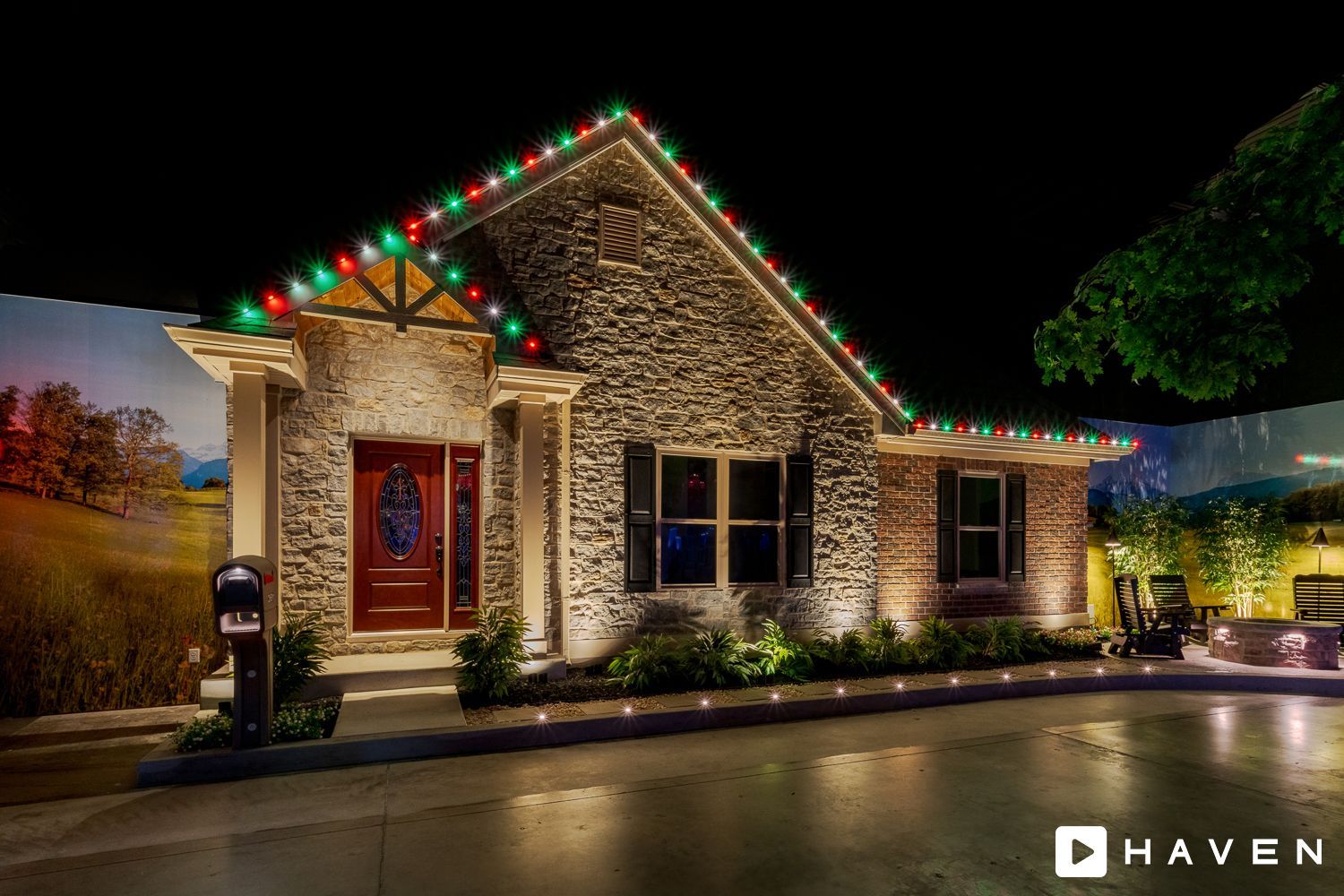 A house with christmas lights on it is lit up at night.