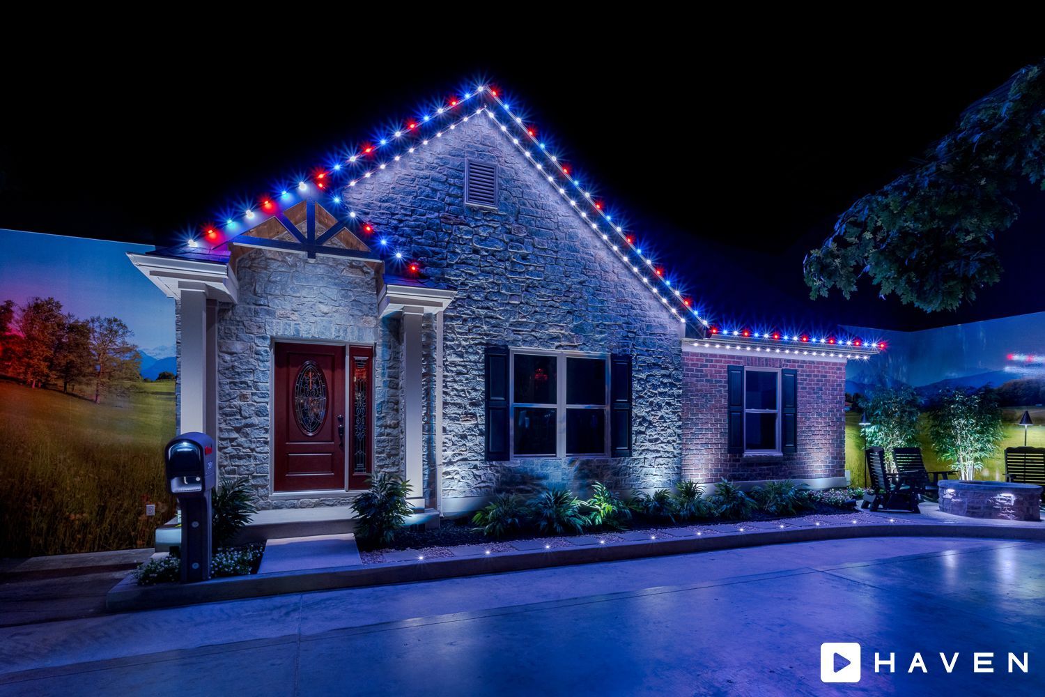A house with christmas lights on it is lit up at night.
