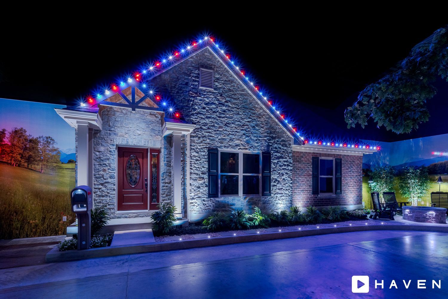 A house with christmas lights on the roof is lit up at night.