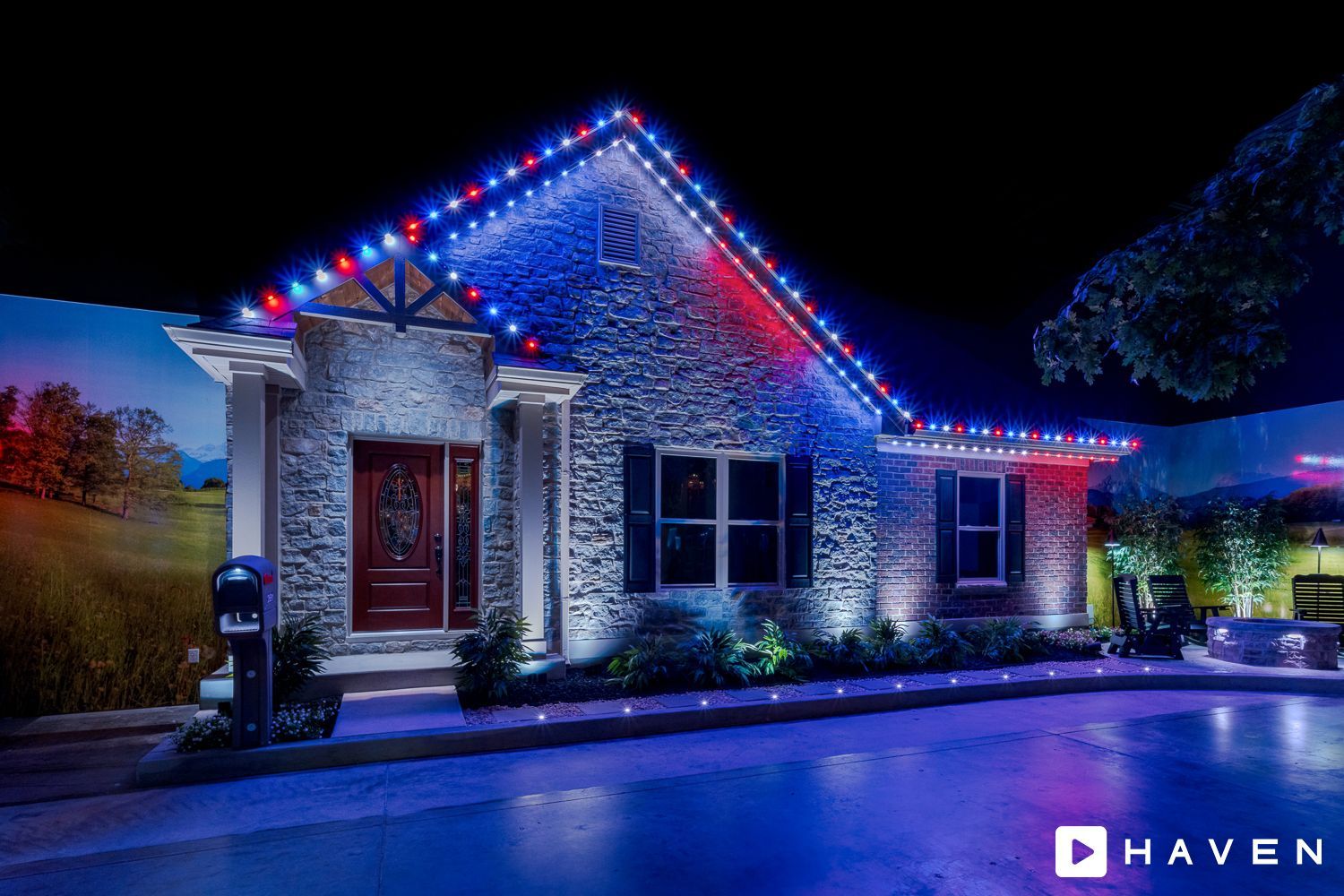 A house is decorated with red , white and blue christmas lights.
