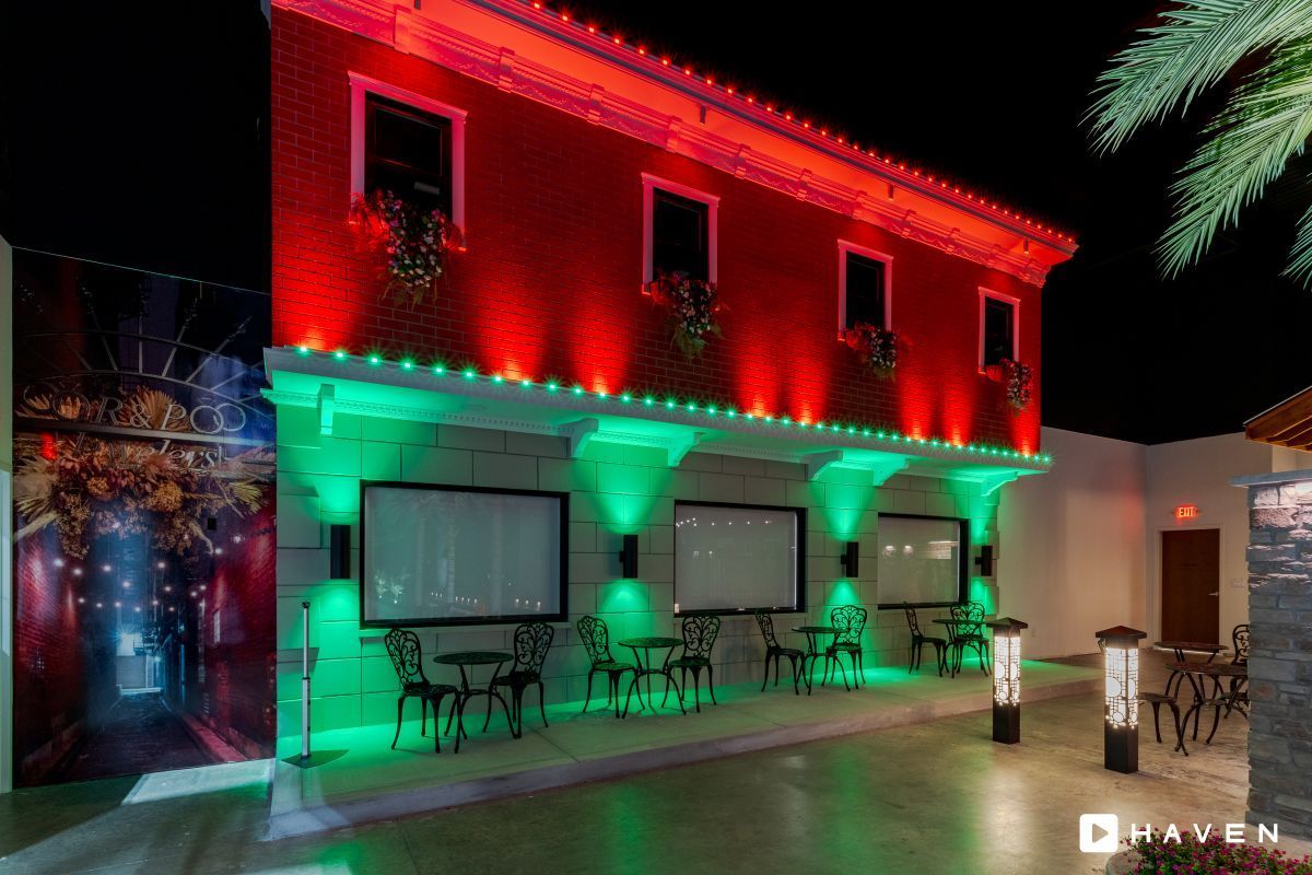 A red building with green lights on the side of it