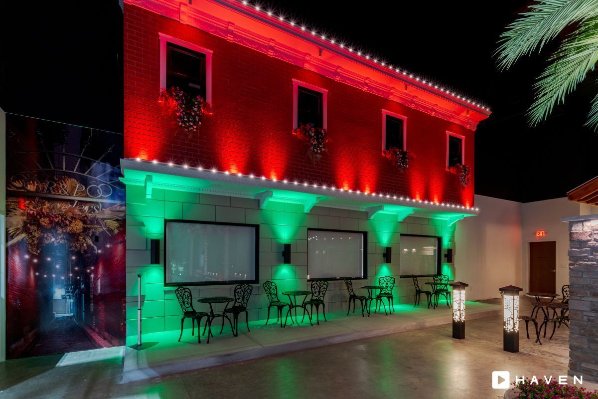 A red building with green lights on the side of it