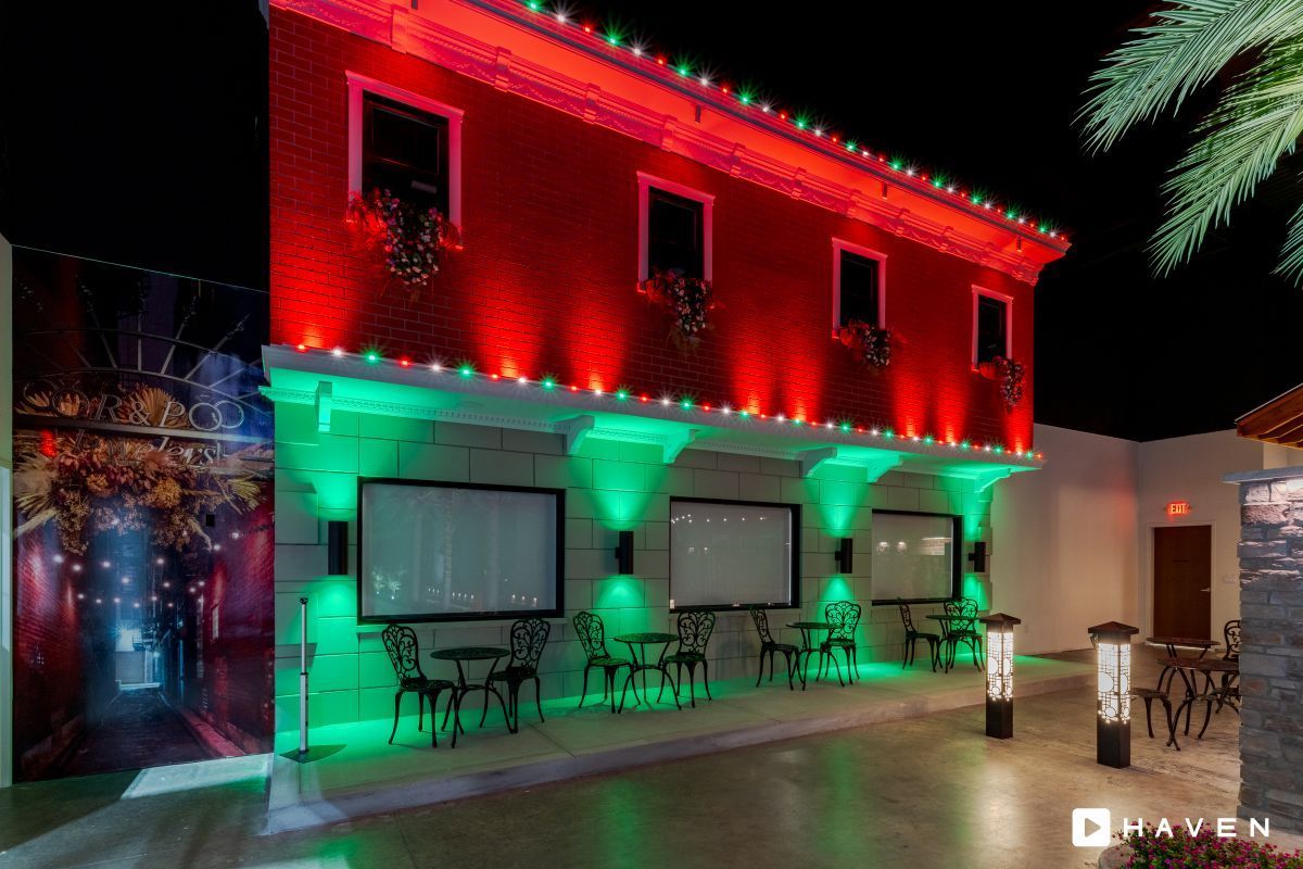 A red building with green lights on the side of it
