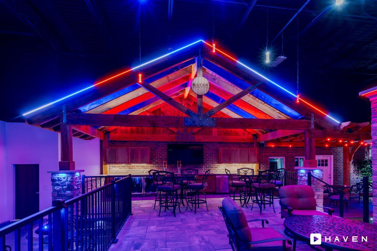 A restaurant with red , white and blue lights on the ceiling.