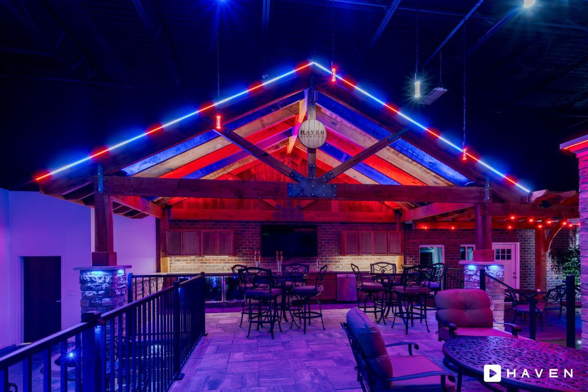 A restaurant with red , white and blue lights on the ceiling.