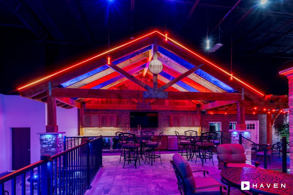 A restaurant with red , white and blue lights on the ceiling.