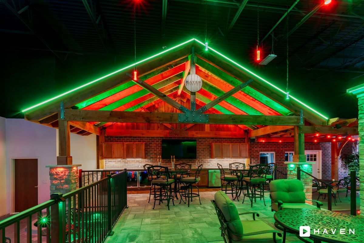 A large room with a roof that is lit up with green and red lights.