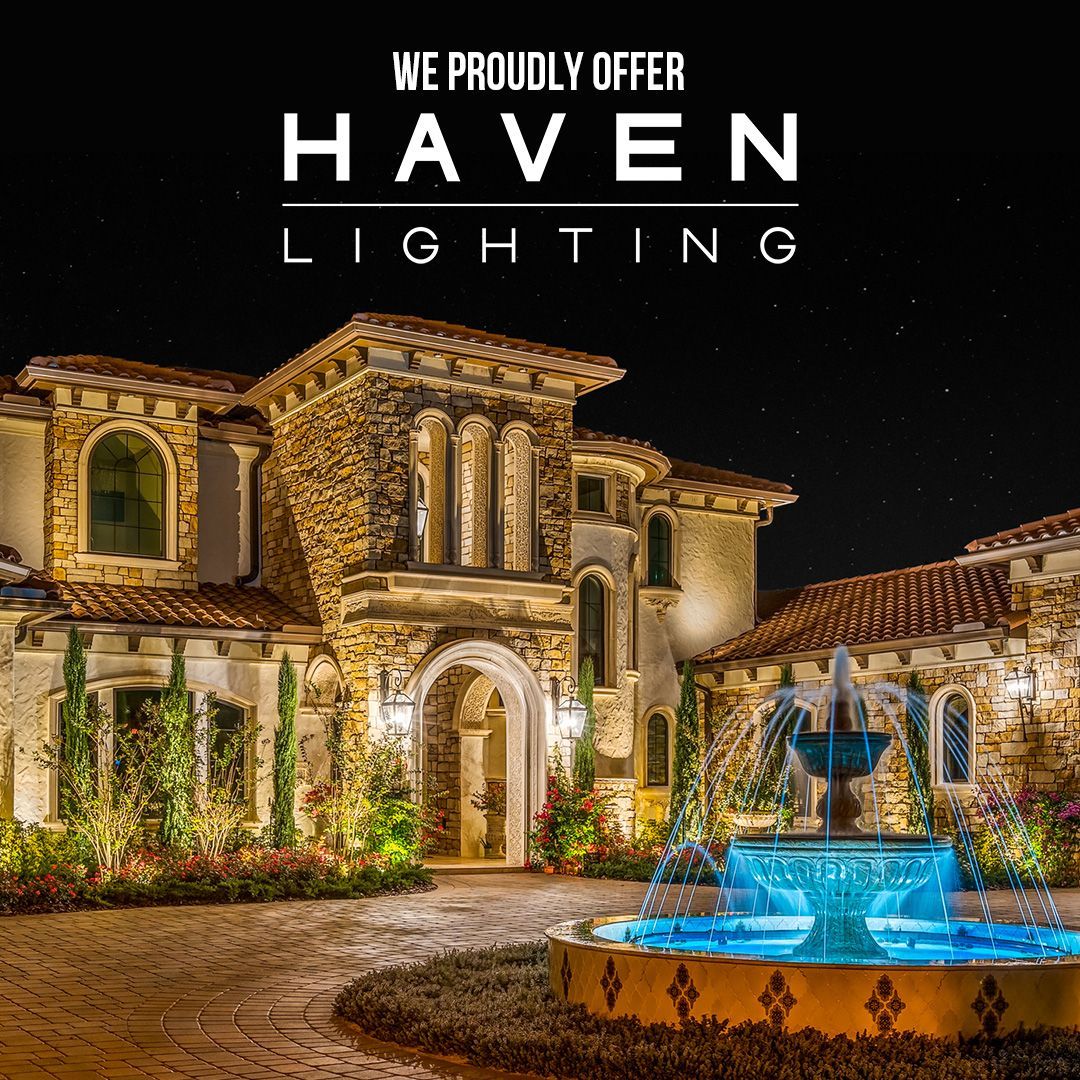 A large house with a fountain in front of it.