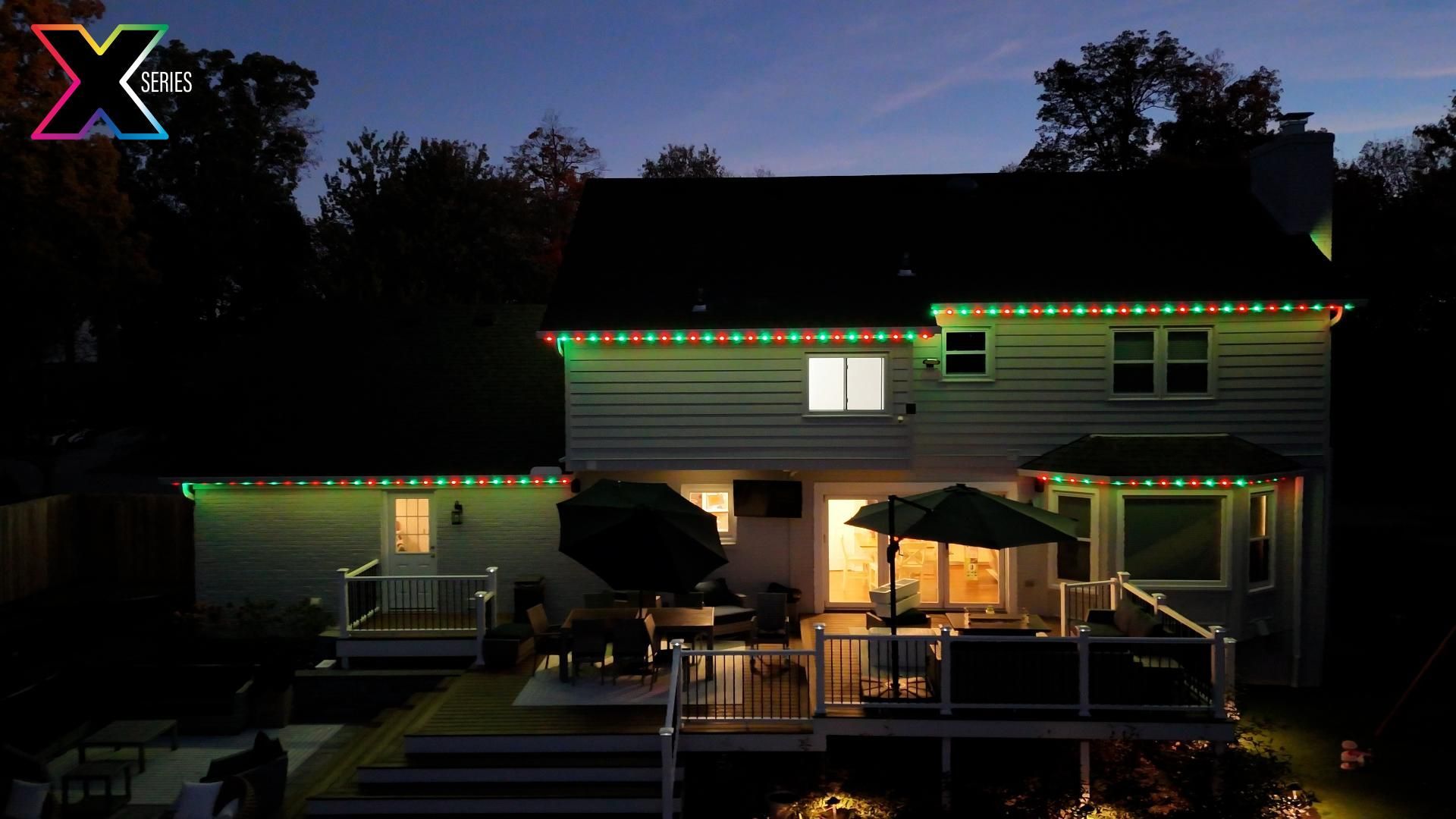 An aerial view of a house with christmas lights on it