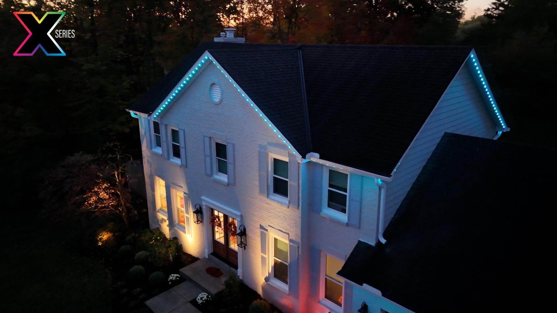 An aerial view of a house with christmas lights on it