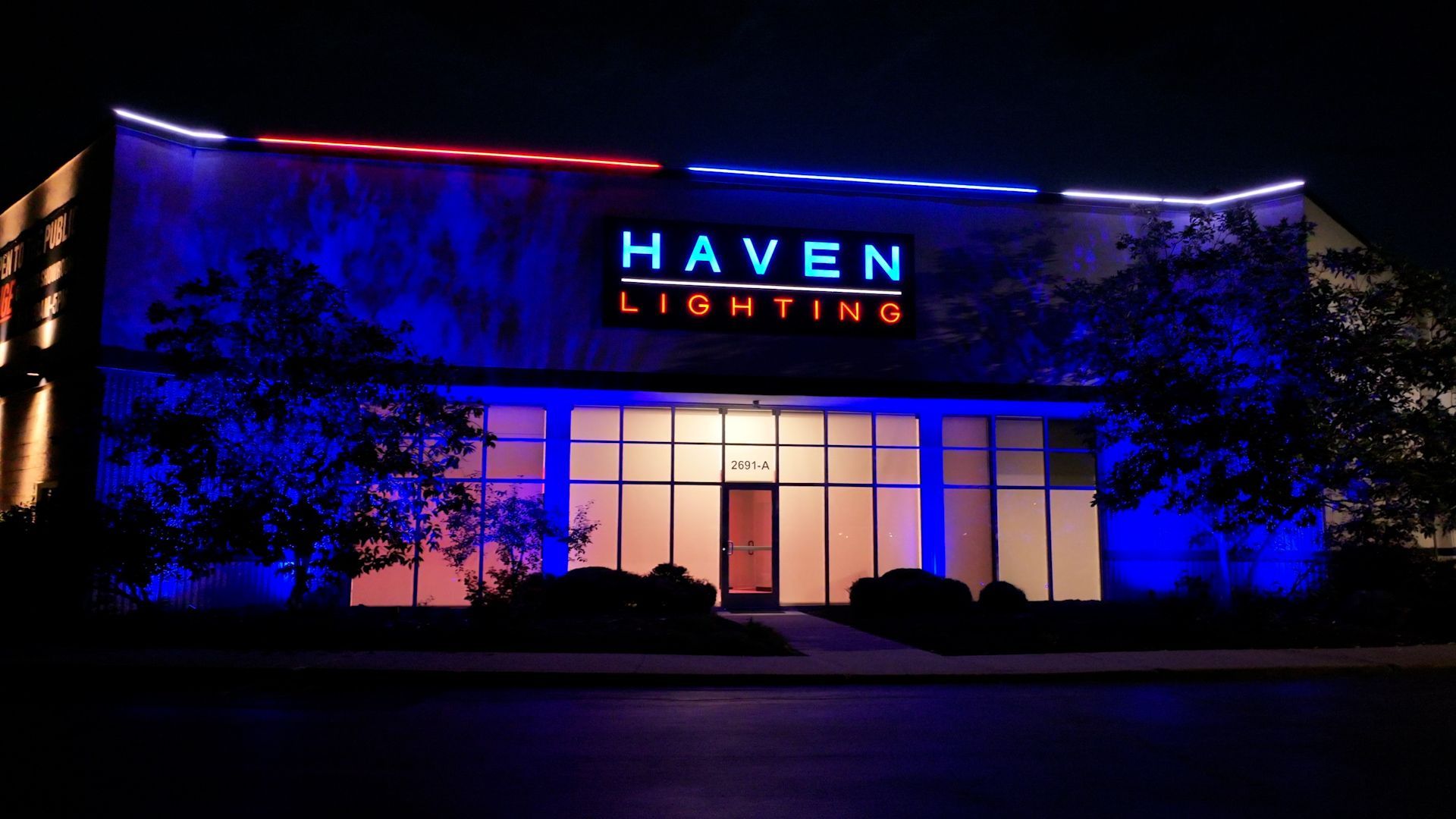 The haven lighting building is lit up at night