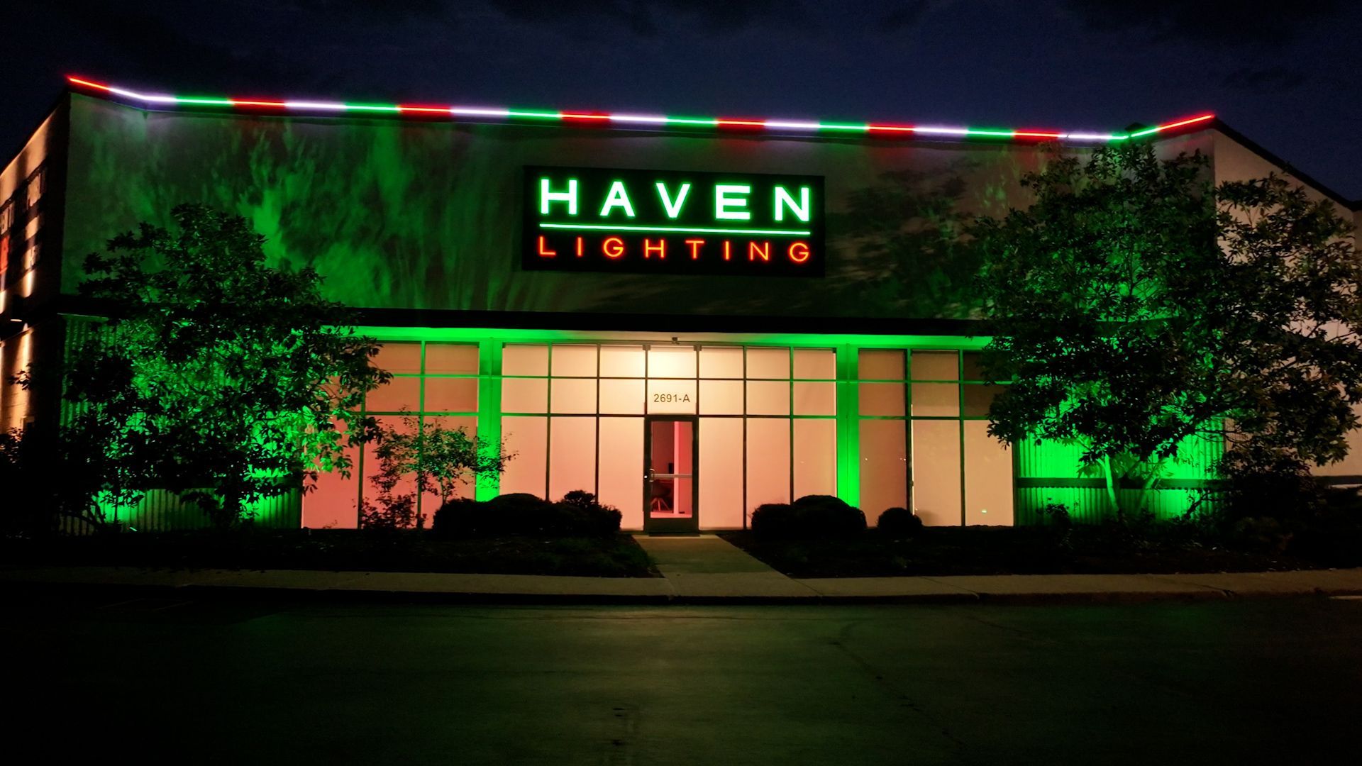The haven lighting building is lit up with green and red lights