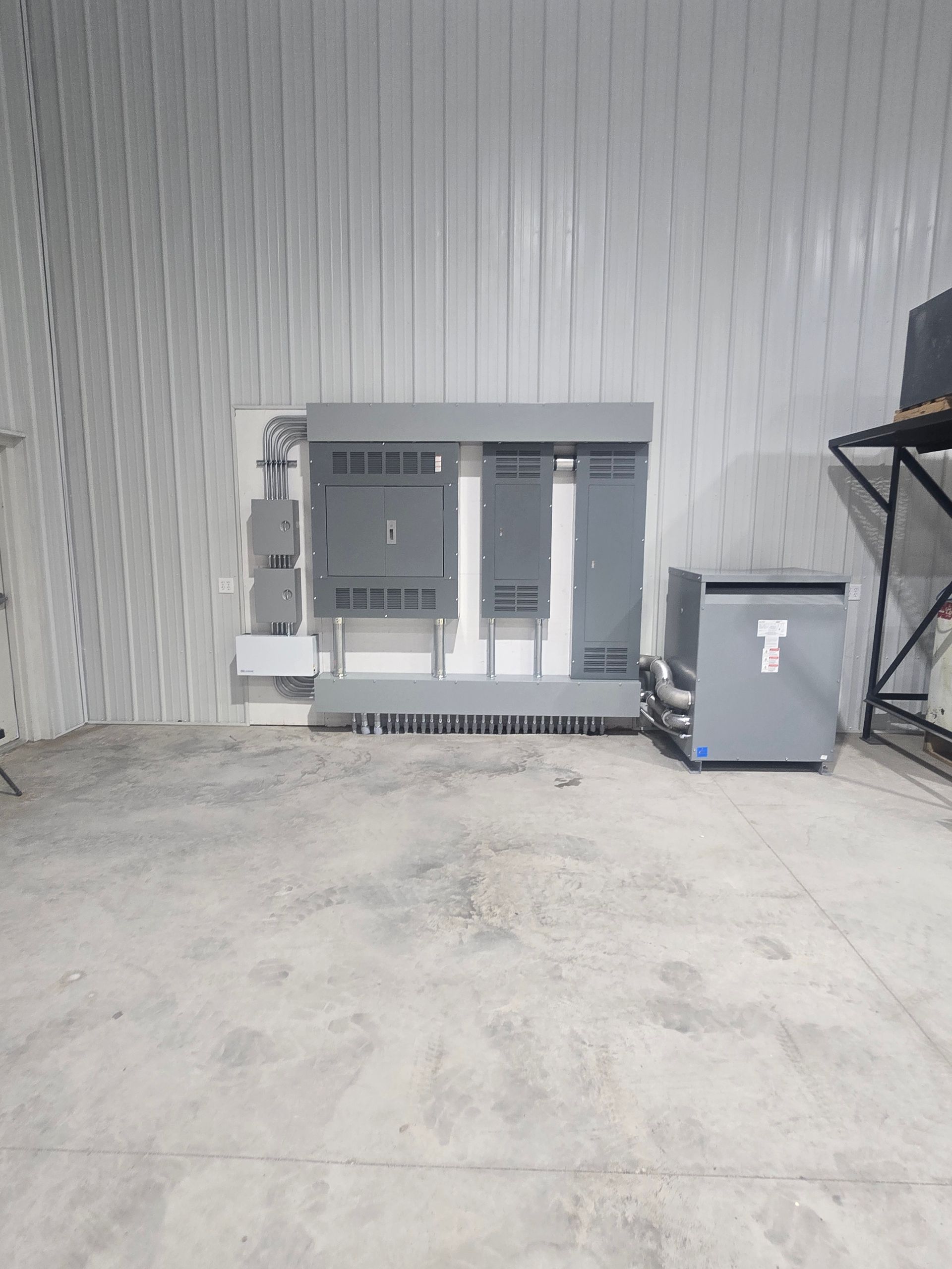 A room with a lot of electrical equipment on the wall.