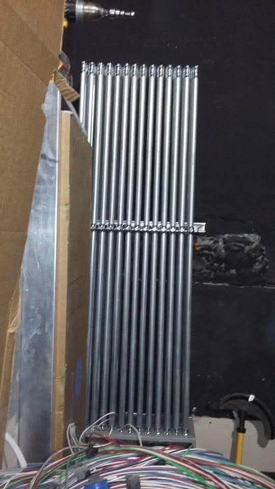 A bunch of metal pipes are stacked on top of each other.