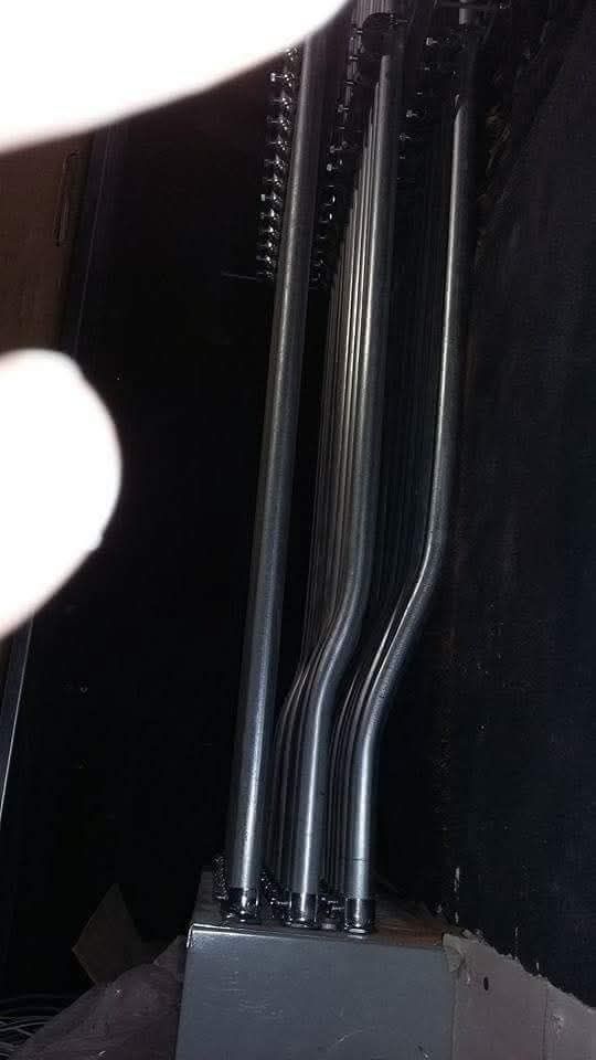 A person is holding a metal pipe in their hand.