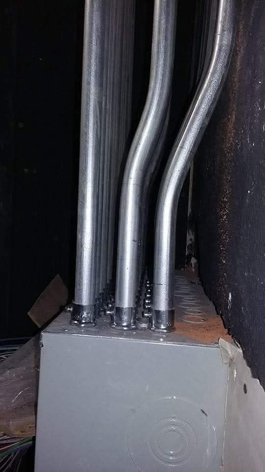 A bunch of metal pipes are connected to a box.
