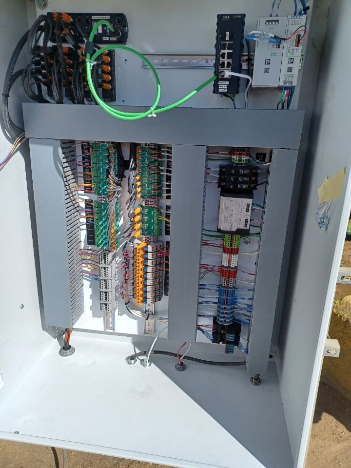 The inside of a electrical box with a lot of wires coming out of it.