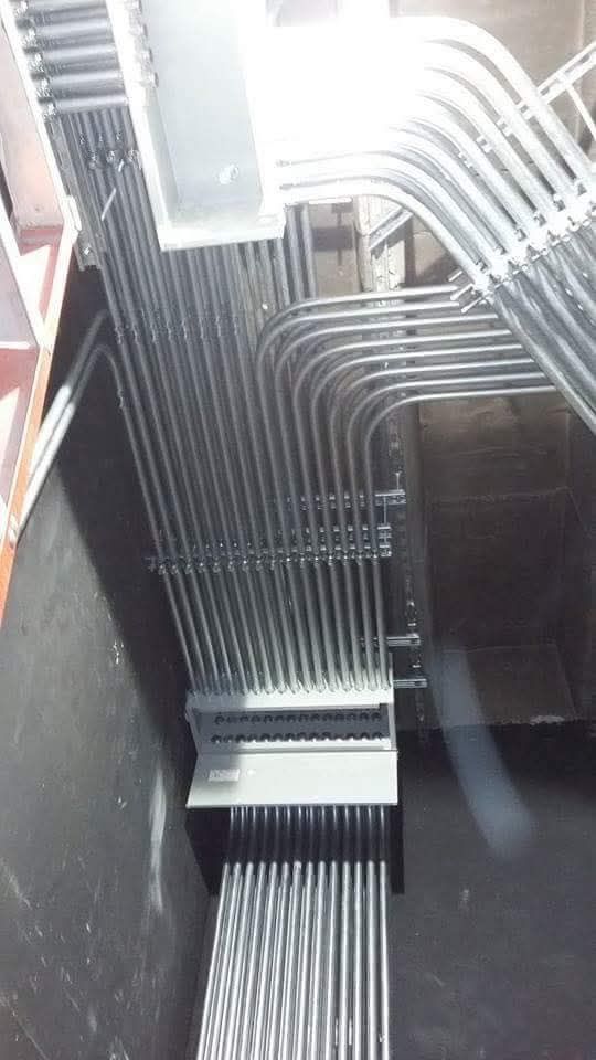 A bunch of metal pipes are connected to each other in a room.