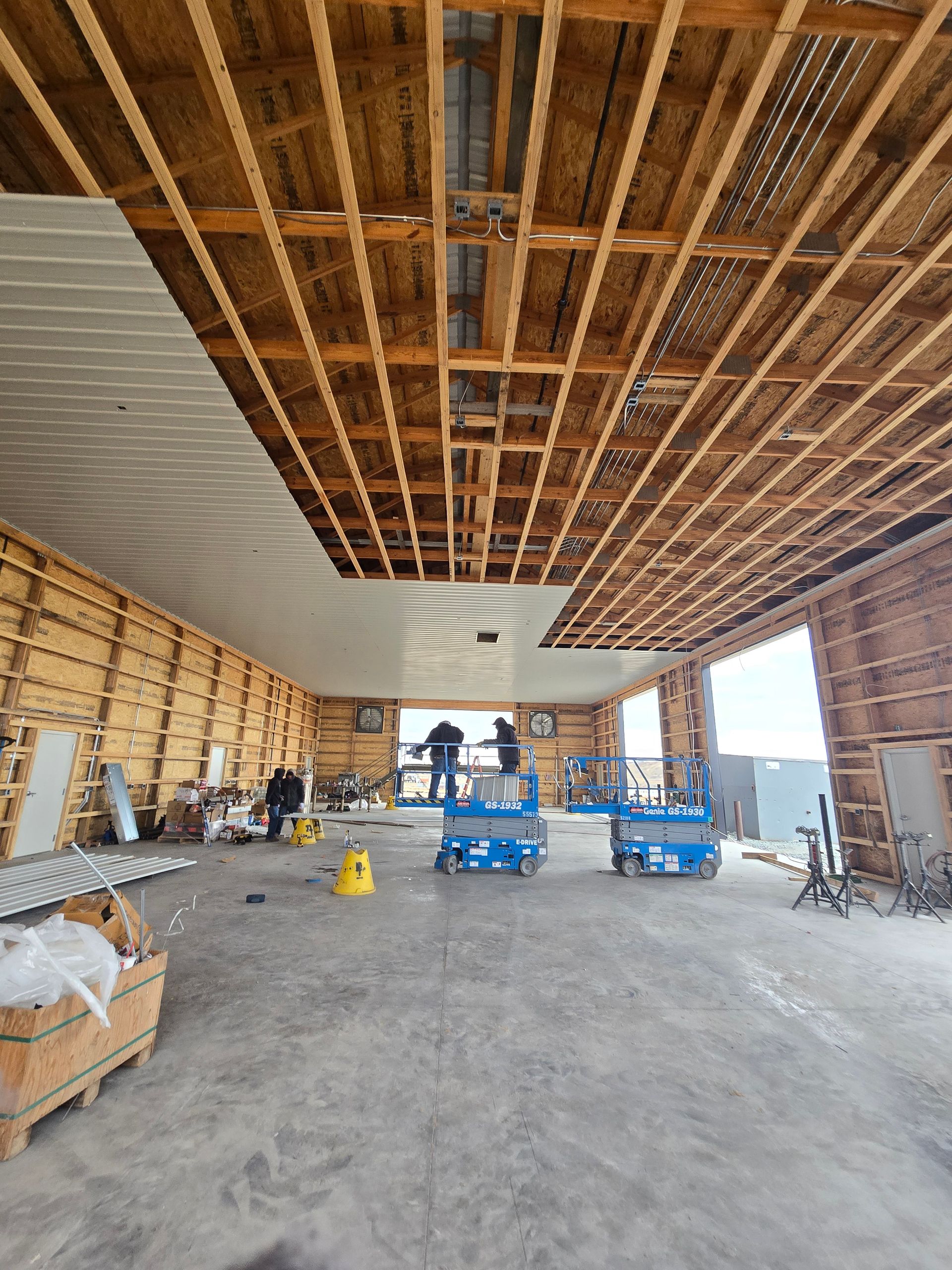 A large room with a ceiling that is being built.