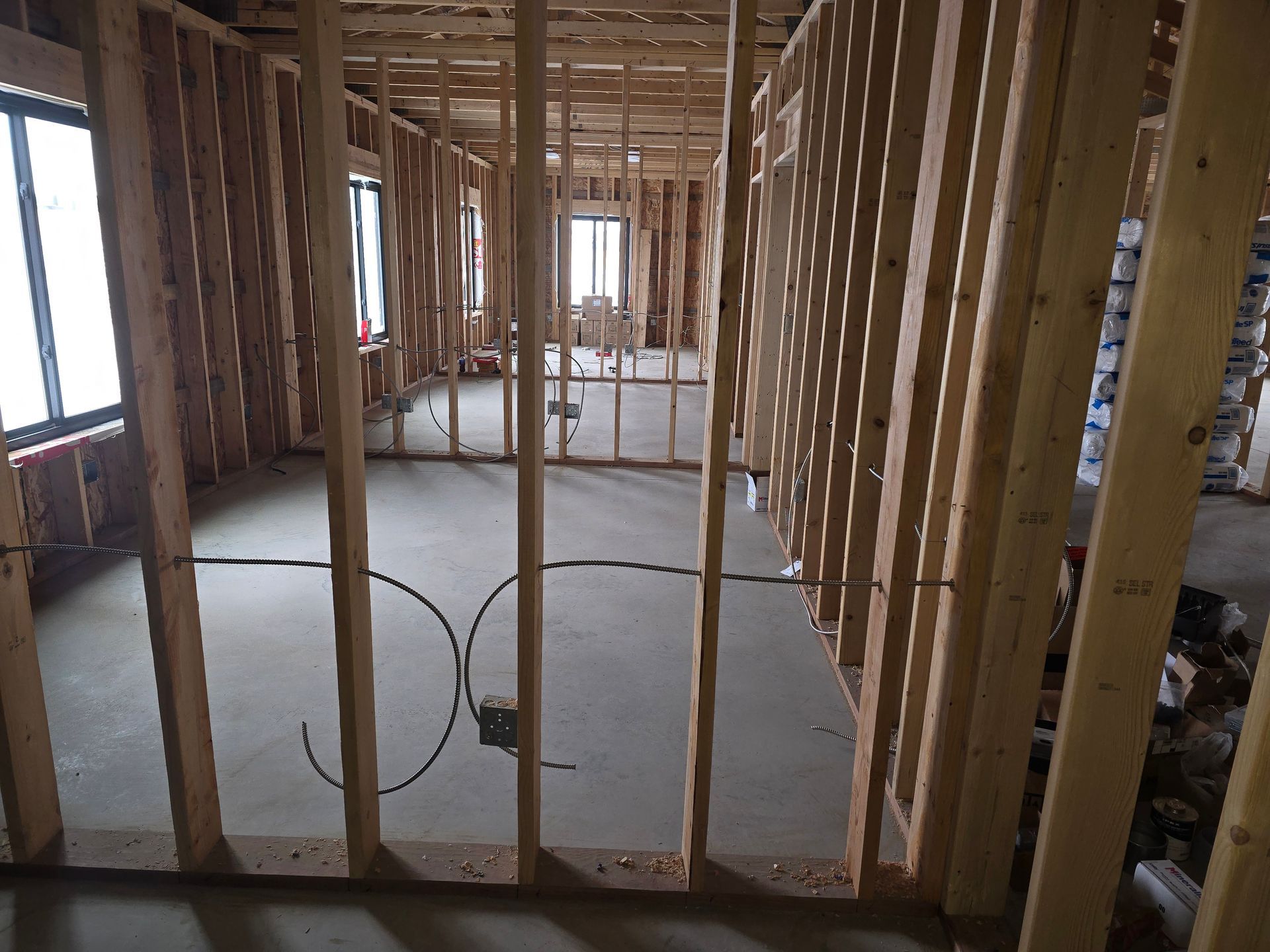 A room under construction with a lot of wooden beams