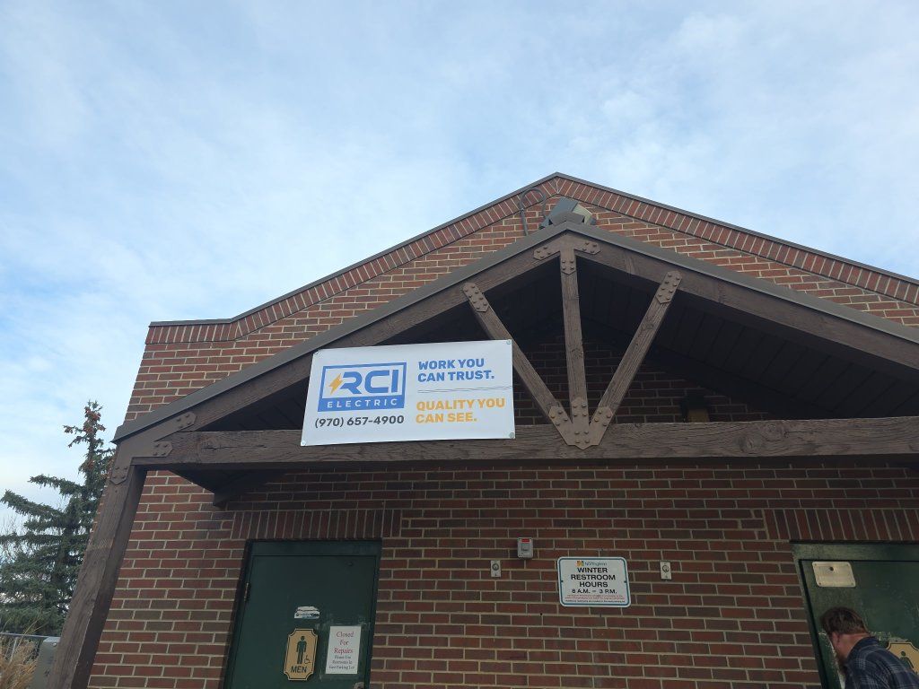 Brick building with brown trim and a banner for RCI and Welcome Center.