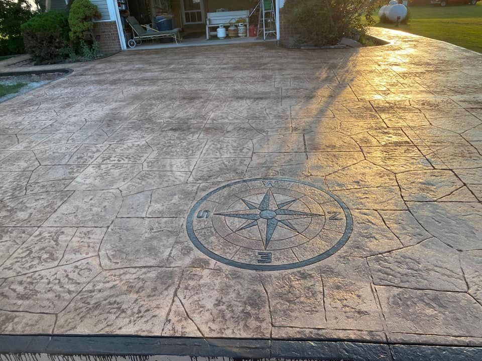 A concrete driveway with a compass on it