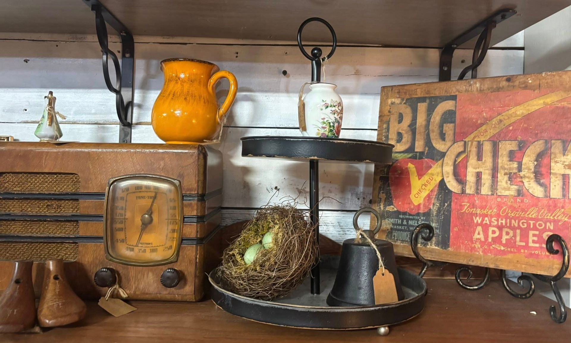vintage items: radio, pitcher, two-tiered tray with bird nest, and sign with 