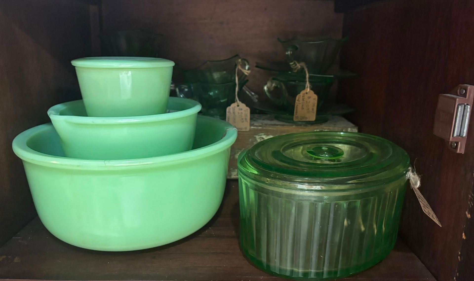 Jadeite green nested mixing bowls and a ribbed jar 