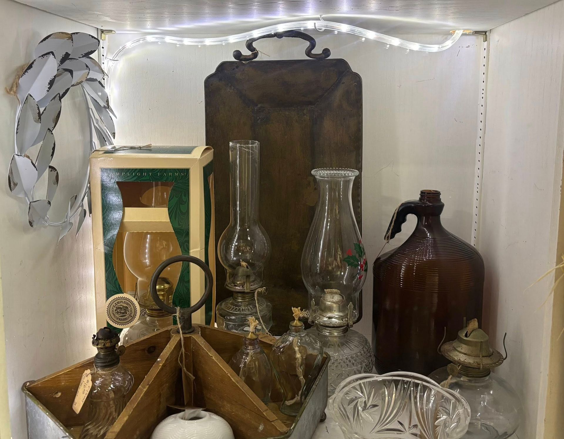  various antique glass bottles, lamps, and a wooden container