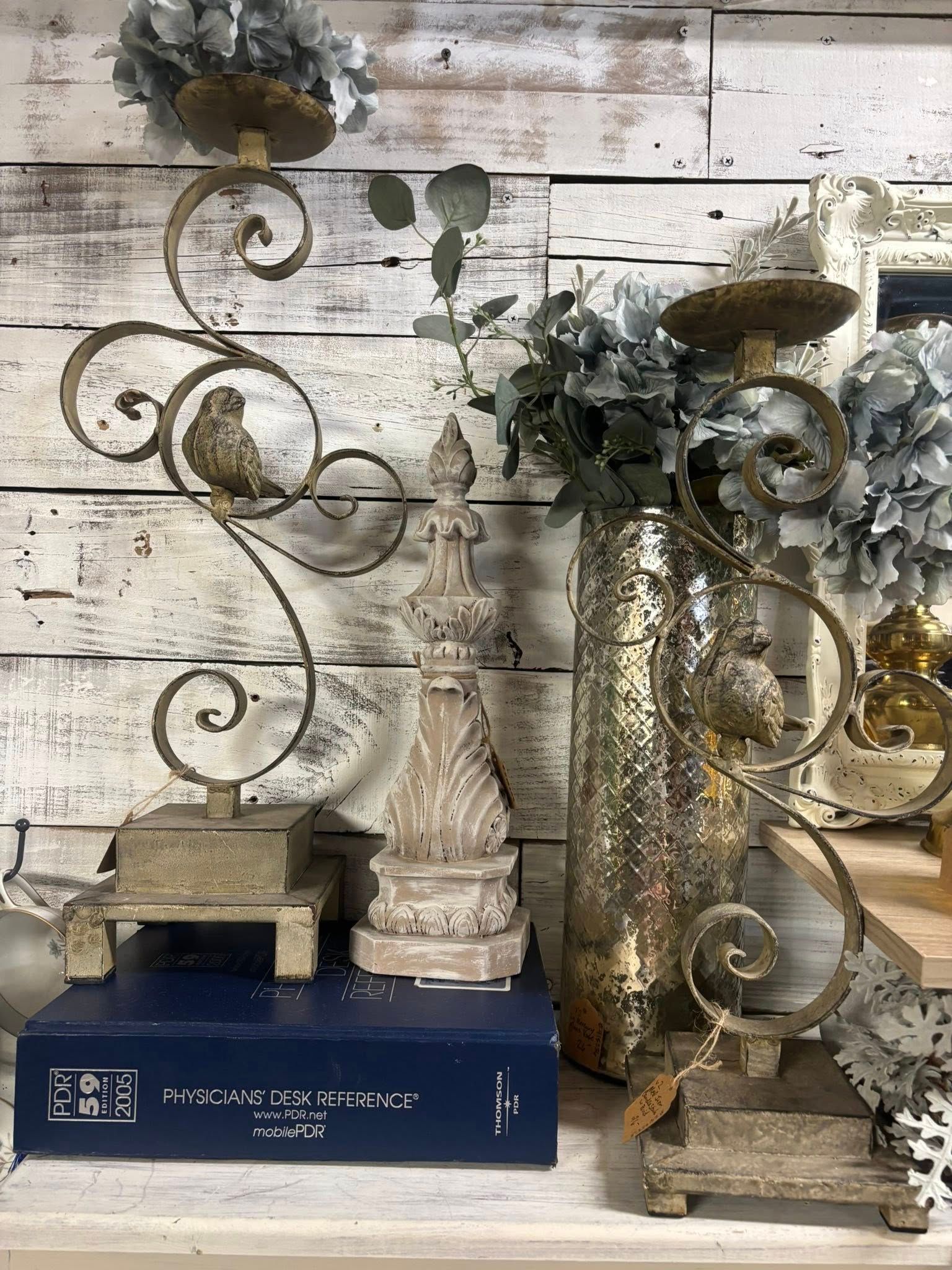 gold candle holders, flowers, and a book