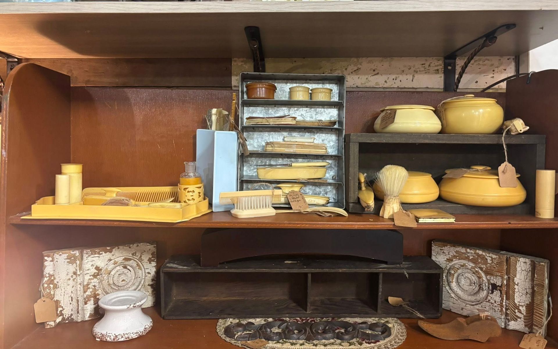 A display of antique bathroom iincluding soaps, brushes, and jars 