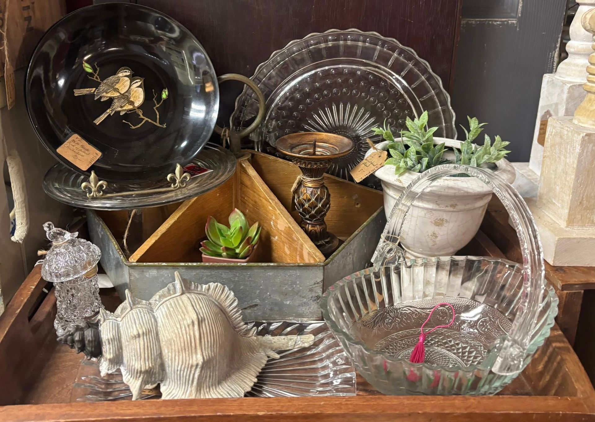 Display
vintage dishes, shells, and plants in a wooden tray.