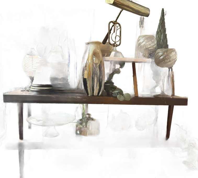 Shelves displaying vintage lamps, vases, and glassware in a shop.