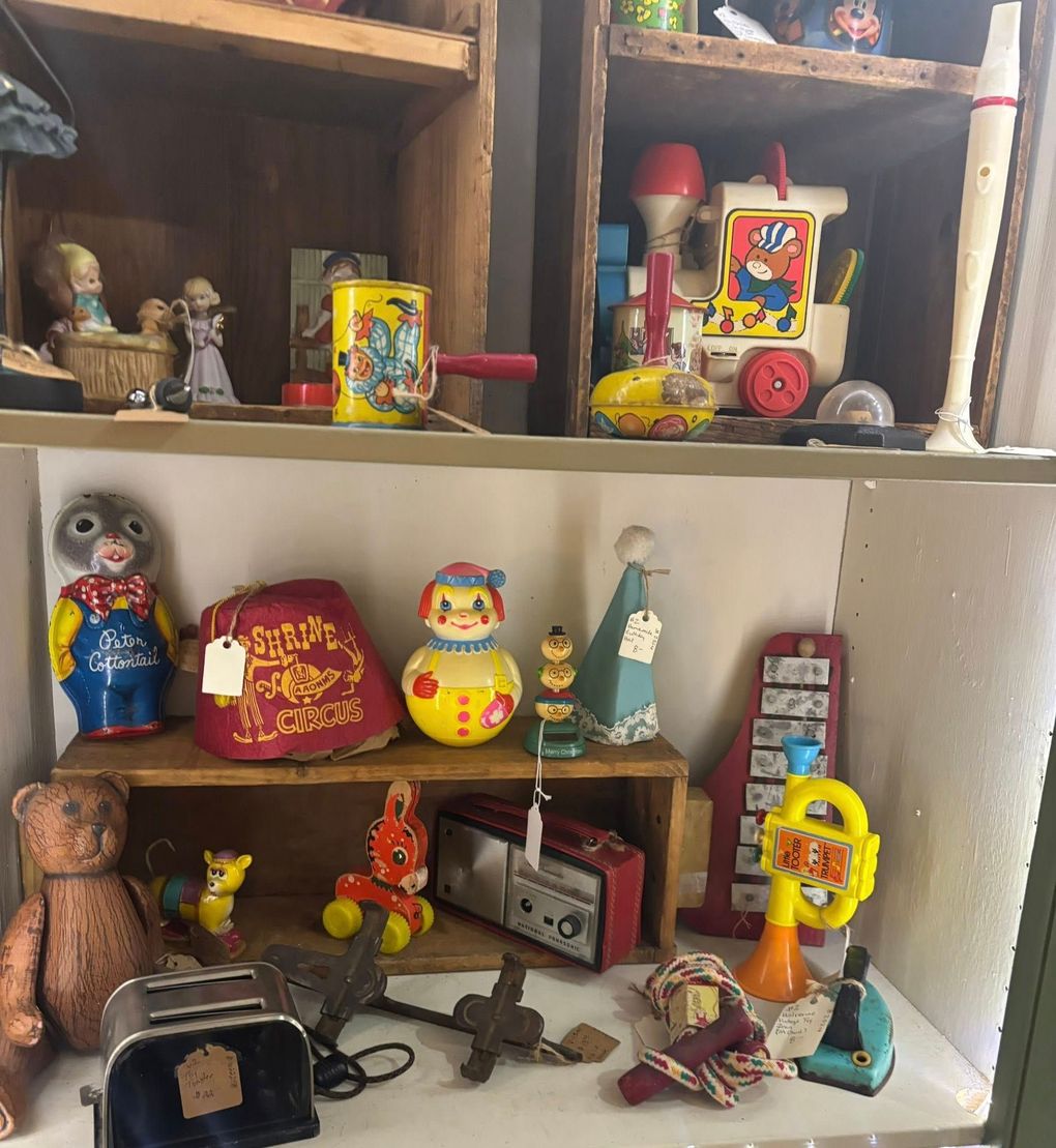 Two wrapped gifts with red snowflake paper and ribbon on a wooden table in a cafe.