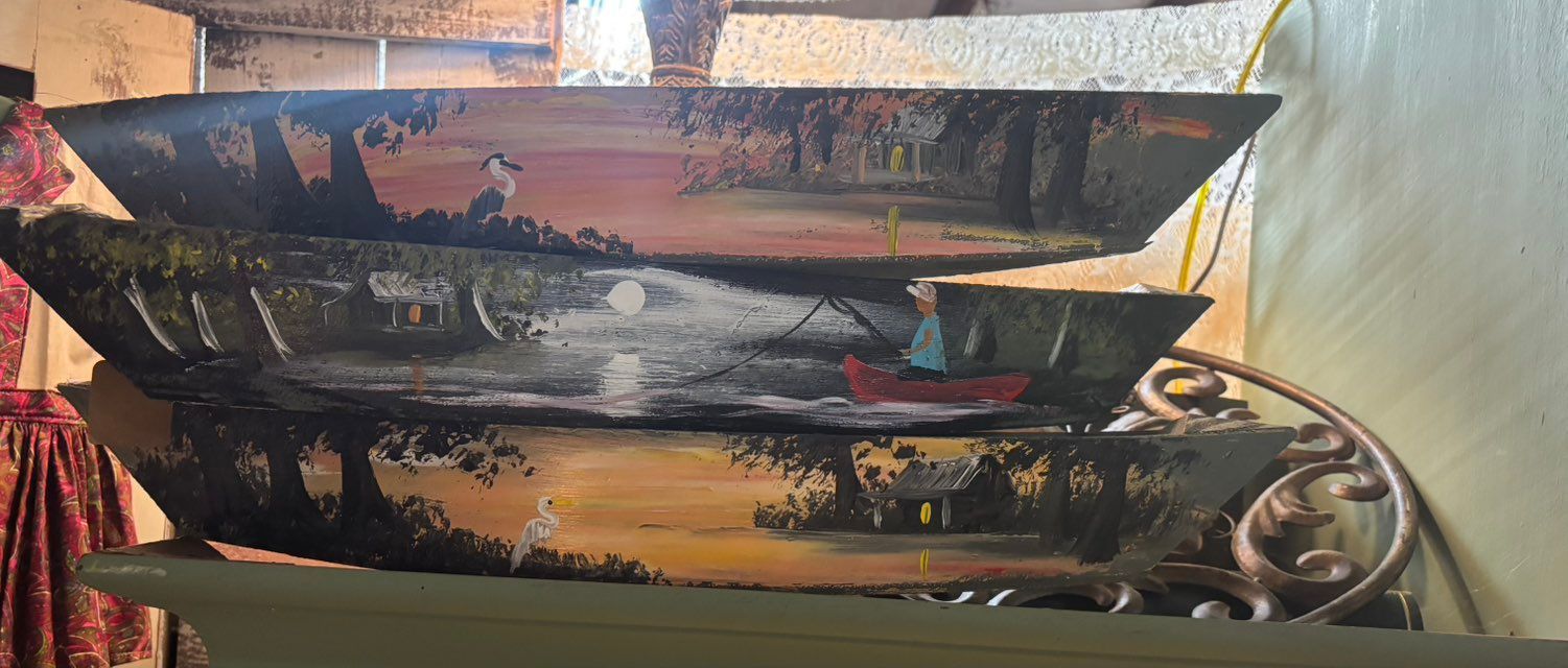 Rodney Lewis hand painted wooden  Each shows a different waterfront scene with trees, and a boat.