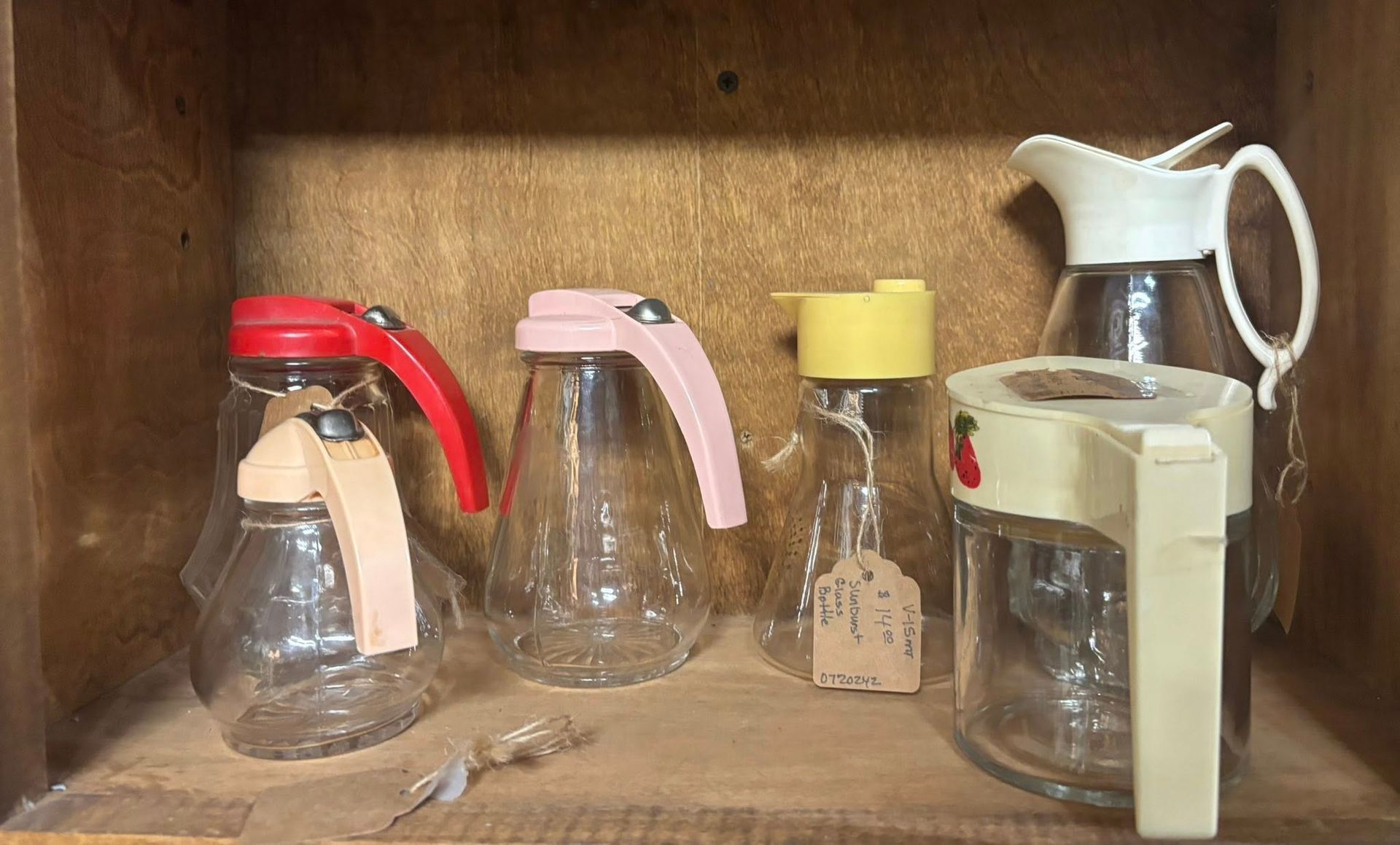 Glass syrup dispensers with colorful lids and handles 