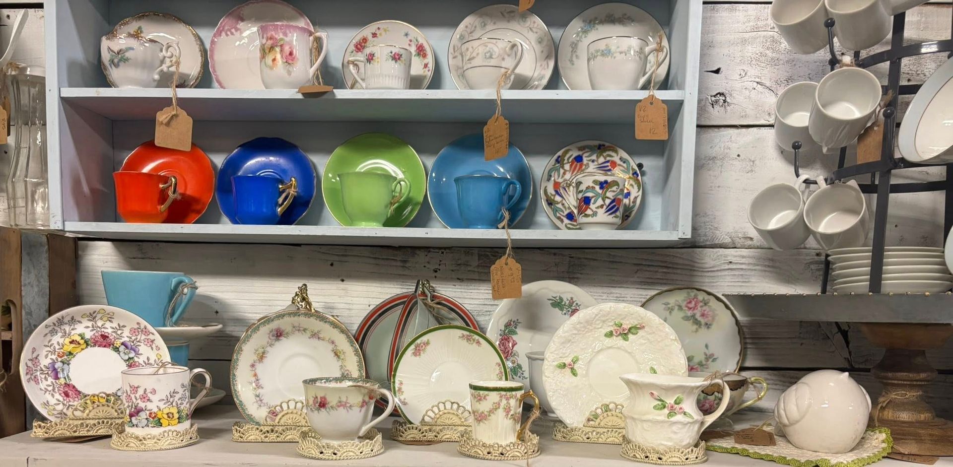 vintage teacups and saucers, with various colors and patterns.