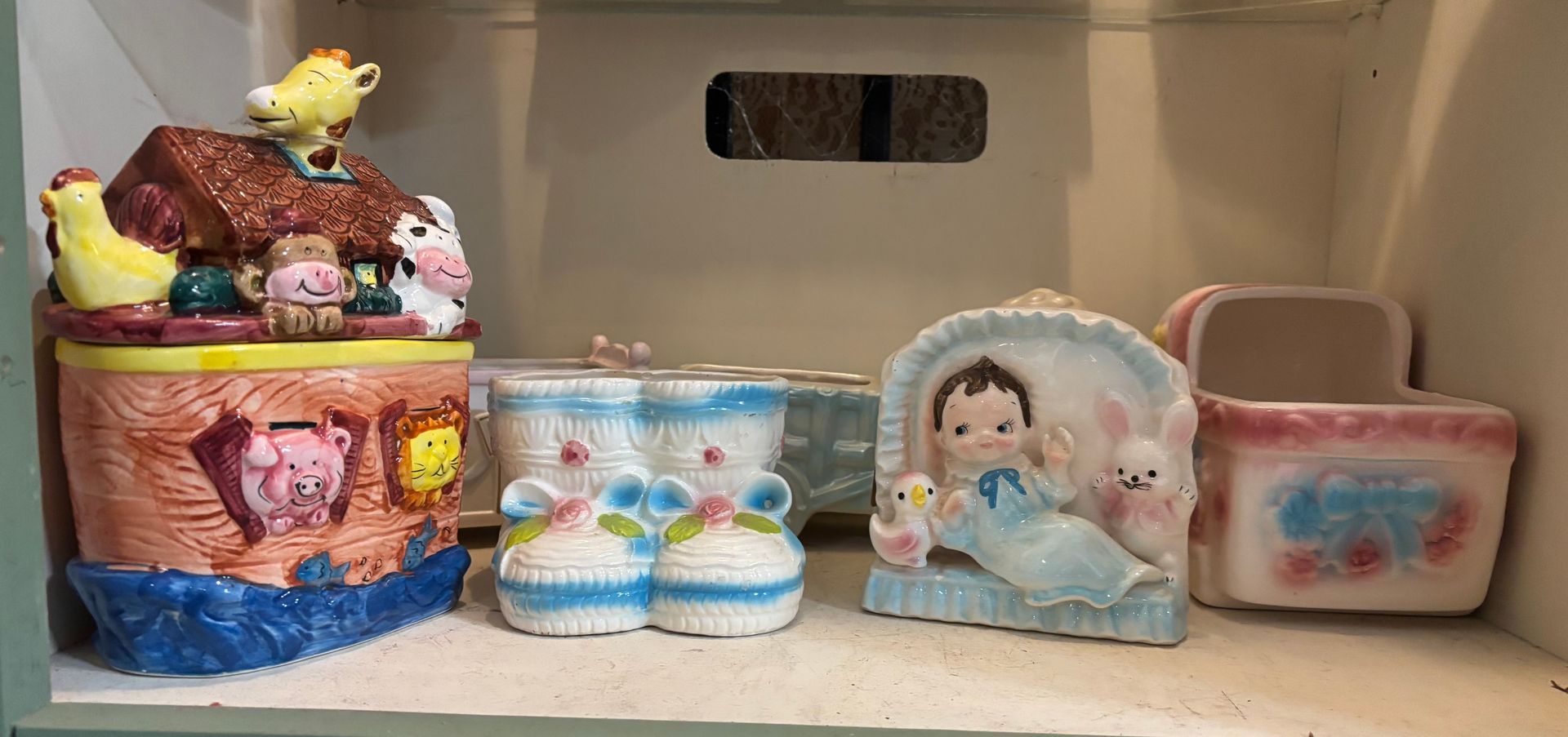 Wooden dresser with mirror and shelves, filled with items. Brown finish, brass hardware.