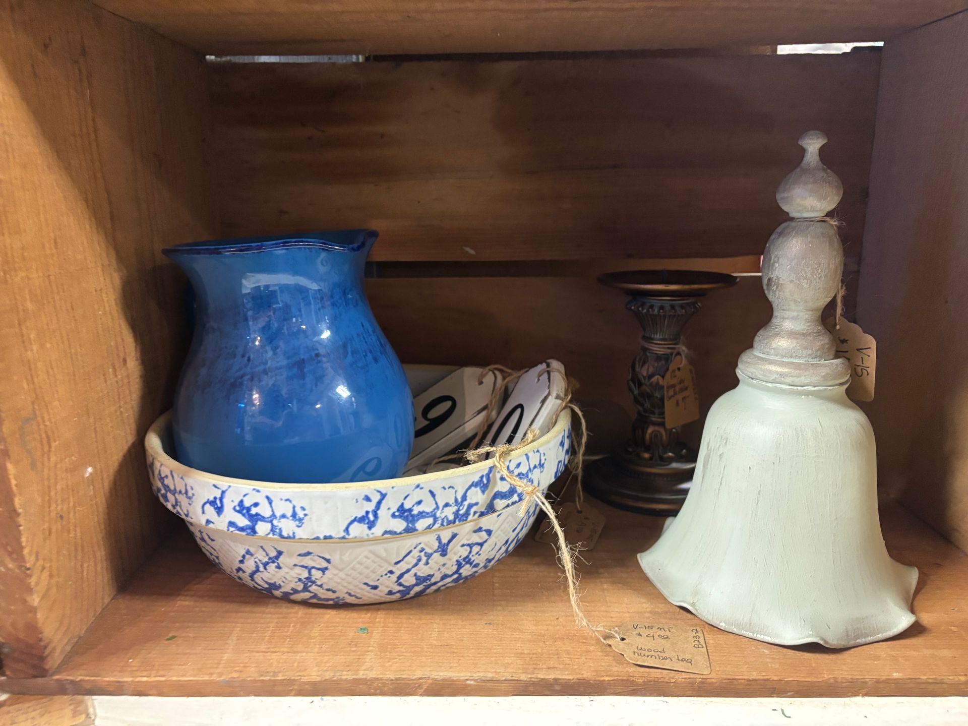 vintage items: glass dish, candlesticks, bird figurine, lace doilies, and fleur-de-lis decoration.