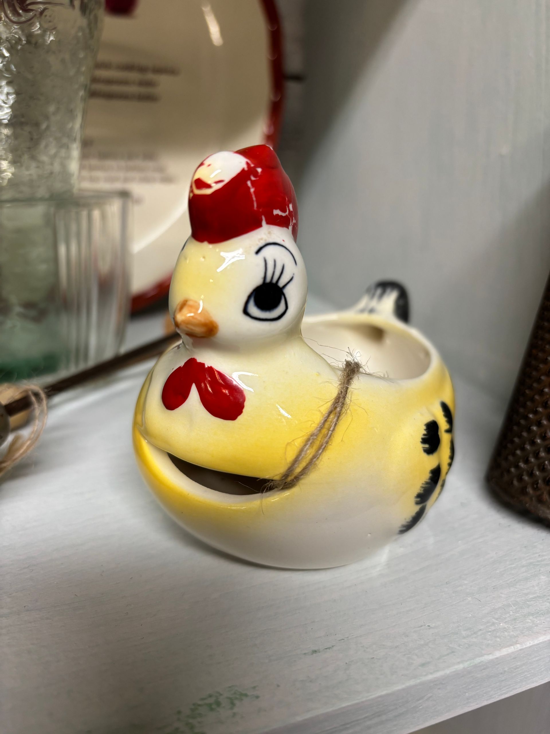 Yellow and white ceramic chicken-shaped egg separator 
