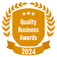 A shield with a laurel wreath and a ribbon that says quality business awards 2024.