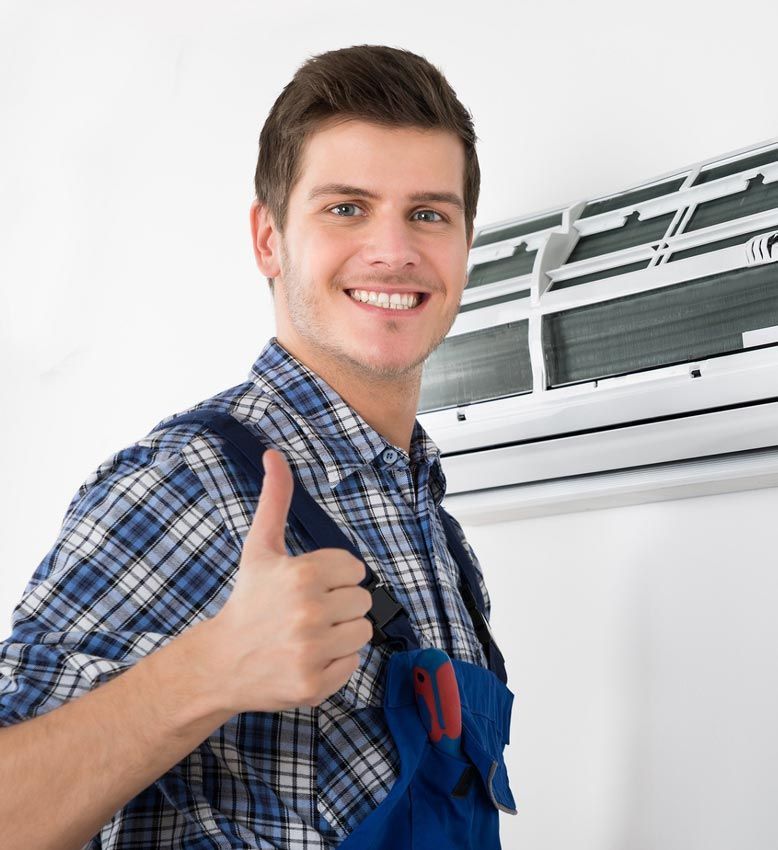 A man is giving a thumbs up in front of an air conditioner