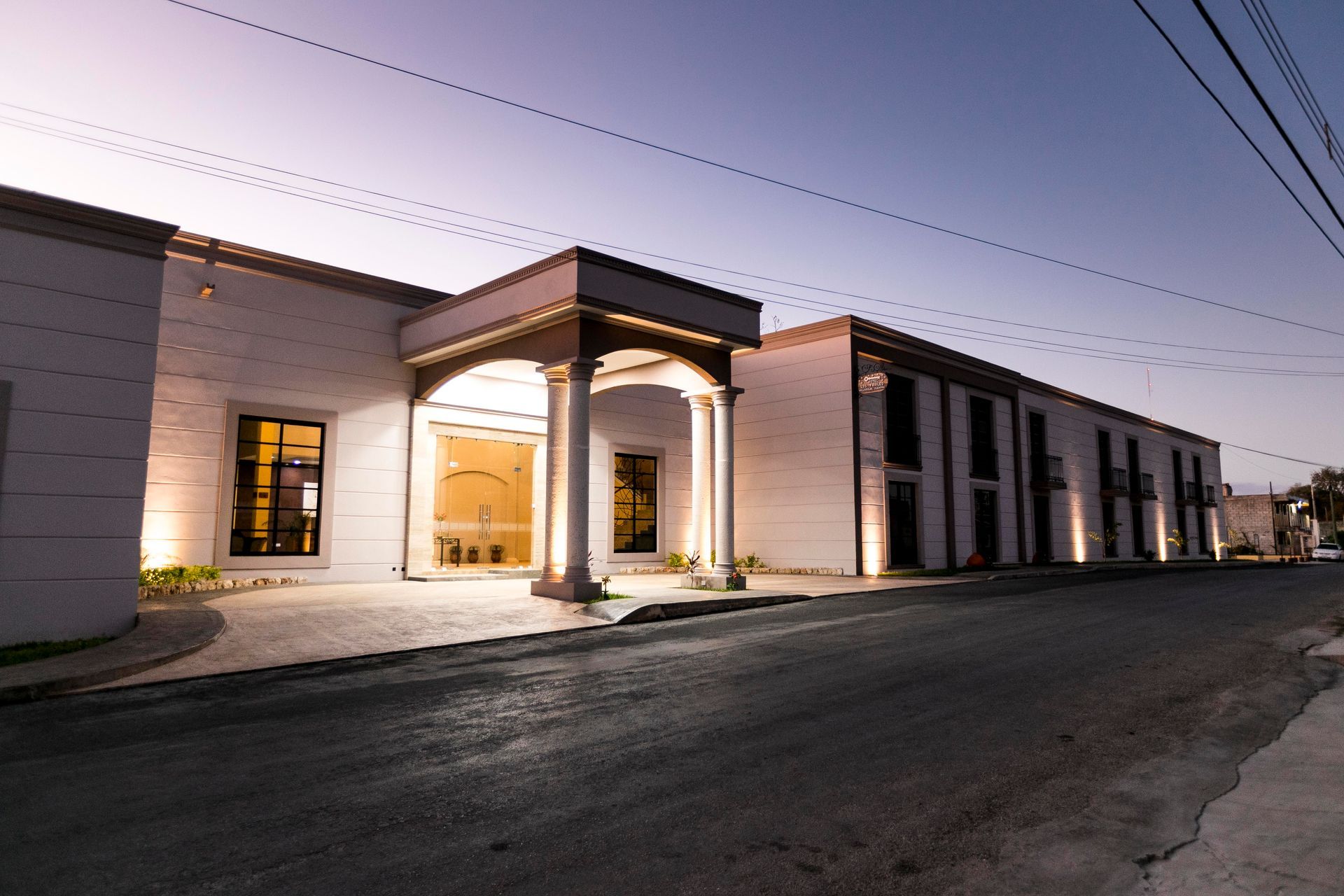 A large white building is lit up at night