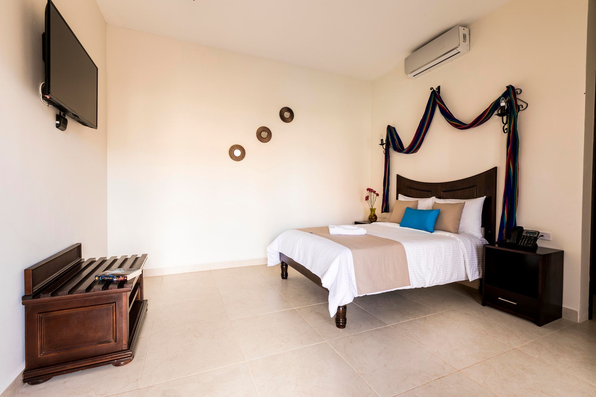 A hotel room with a large bed and a flat screen tv