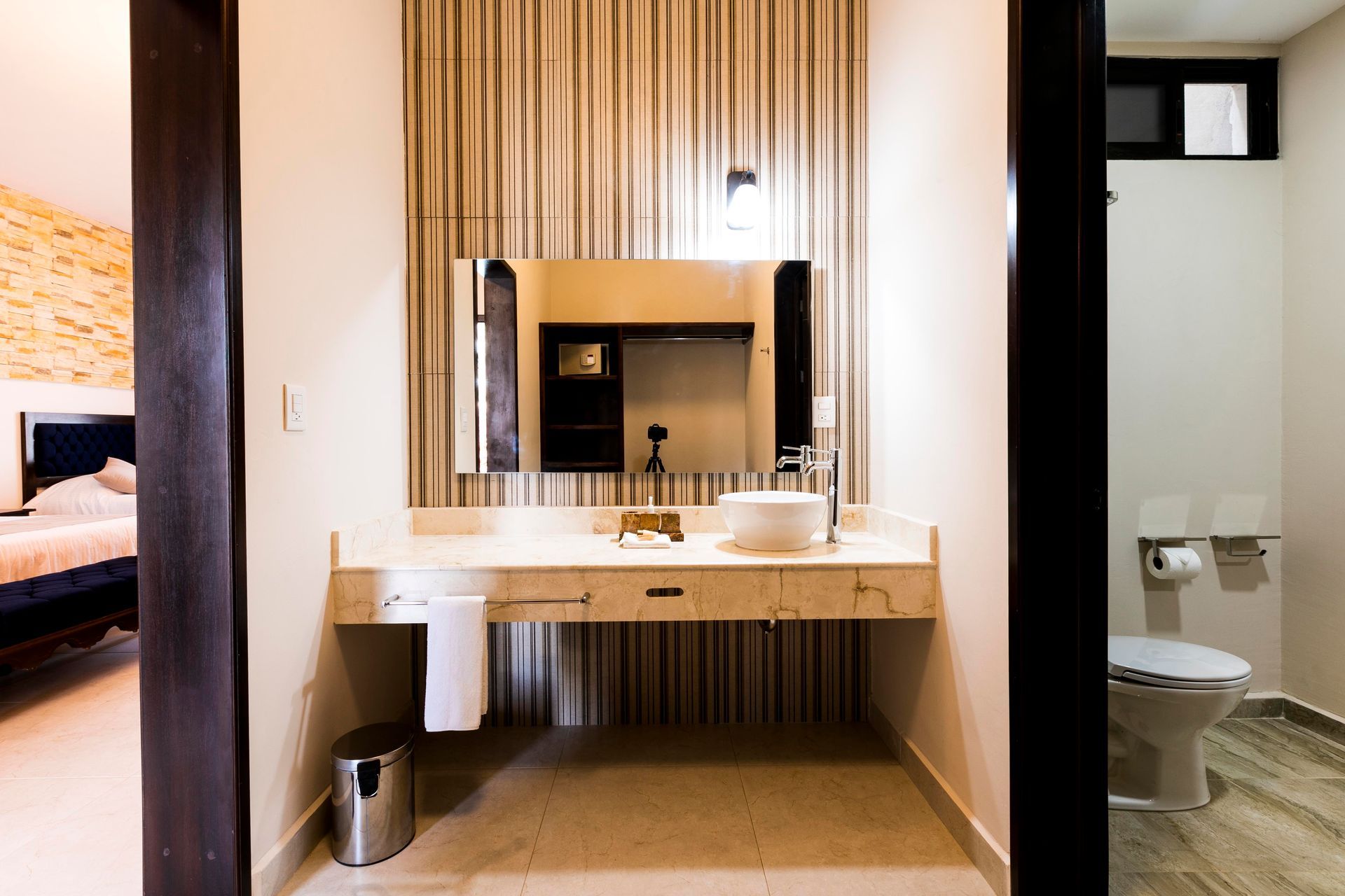 A bathroom with a sink , mirror and toilet.