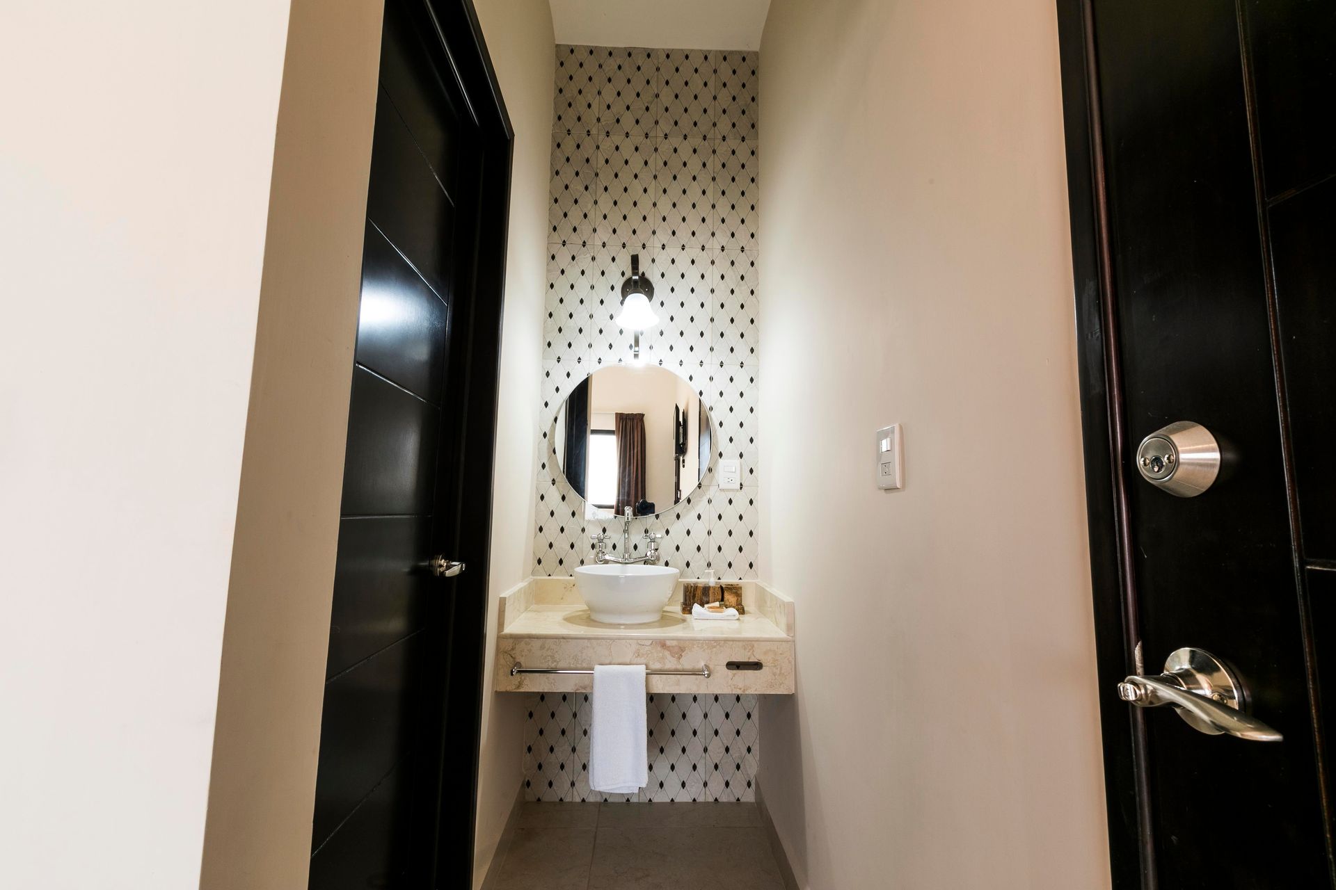 A bathroom with a sink and a mirror in a hotel room.
