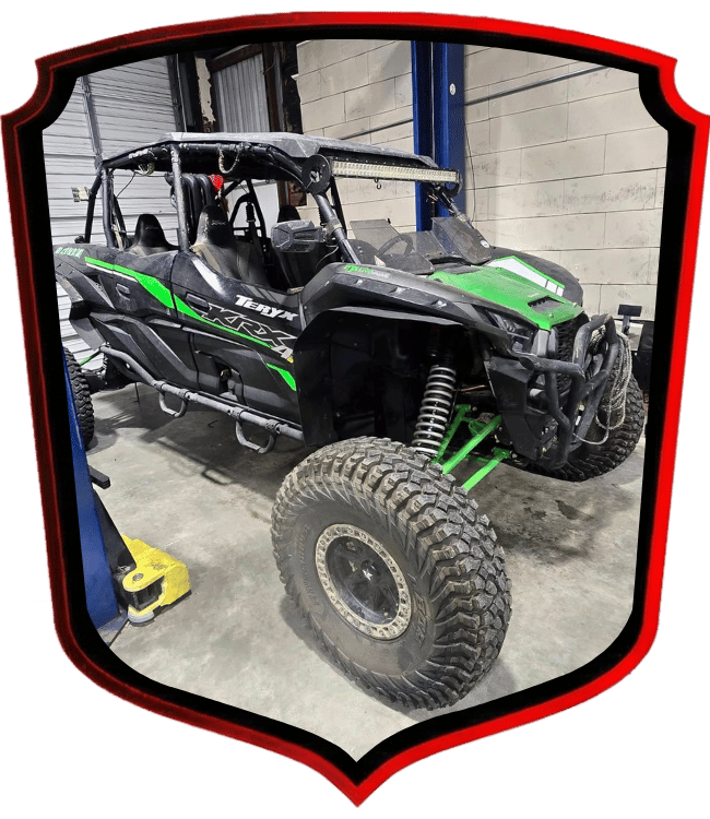 Side-by-side ATV parked inside automotive repair shop